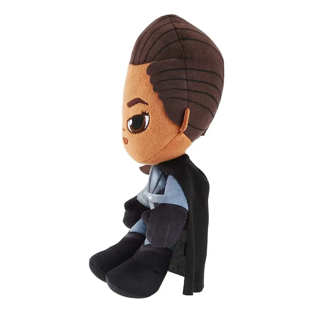 Side view of Star Wars Reva the Third Sister plush in gray uniform with black cape, brown hair detail, oversized head and embroidered facial features, sitting upright.