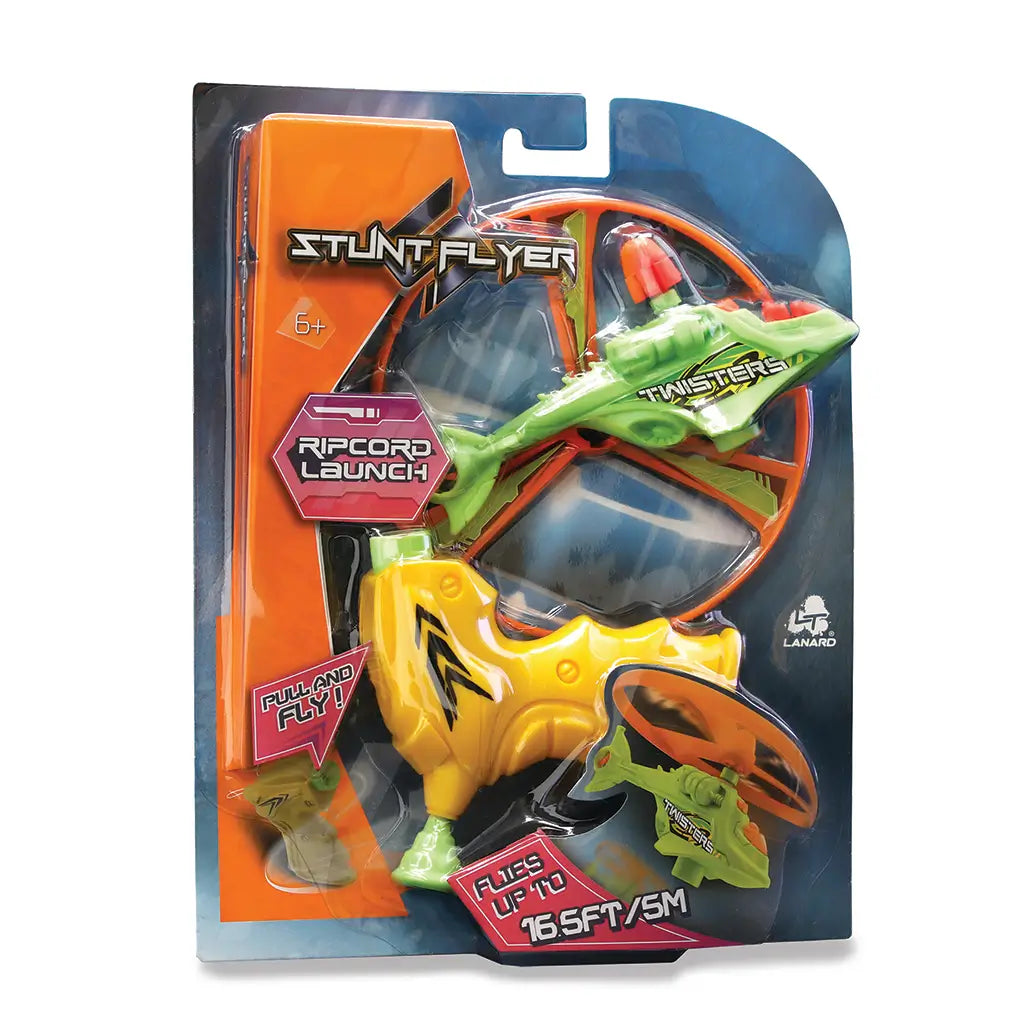 Toy stunt flyer set in retail packaging shows the yellow launcher, green helicopter body and large orange rotor secured in a glossy blister pack with printed graphics highlighting ripcord features.