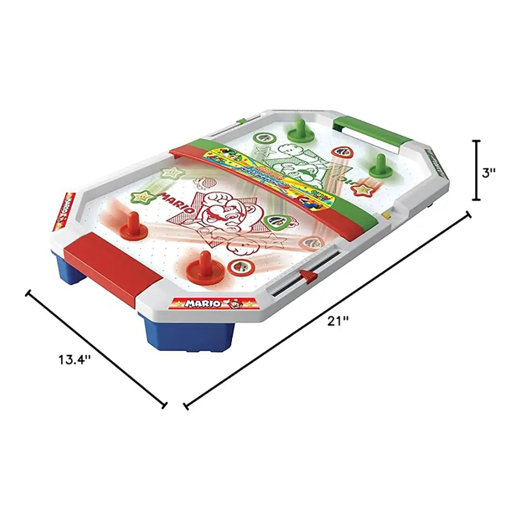 Super Mario air hockey table shown with measurement lines, sized 21 inches by 13.4 inches by 3 inches, with red and green paddles placed on top.