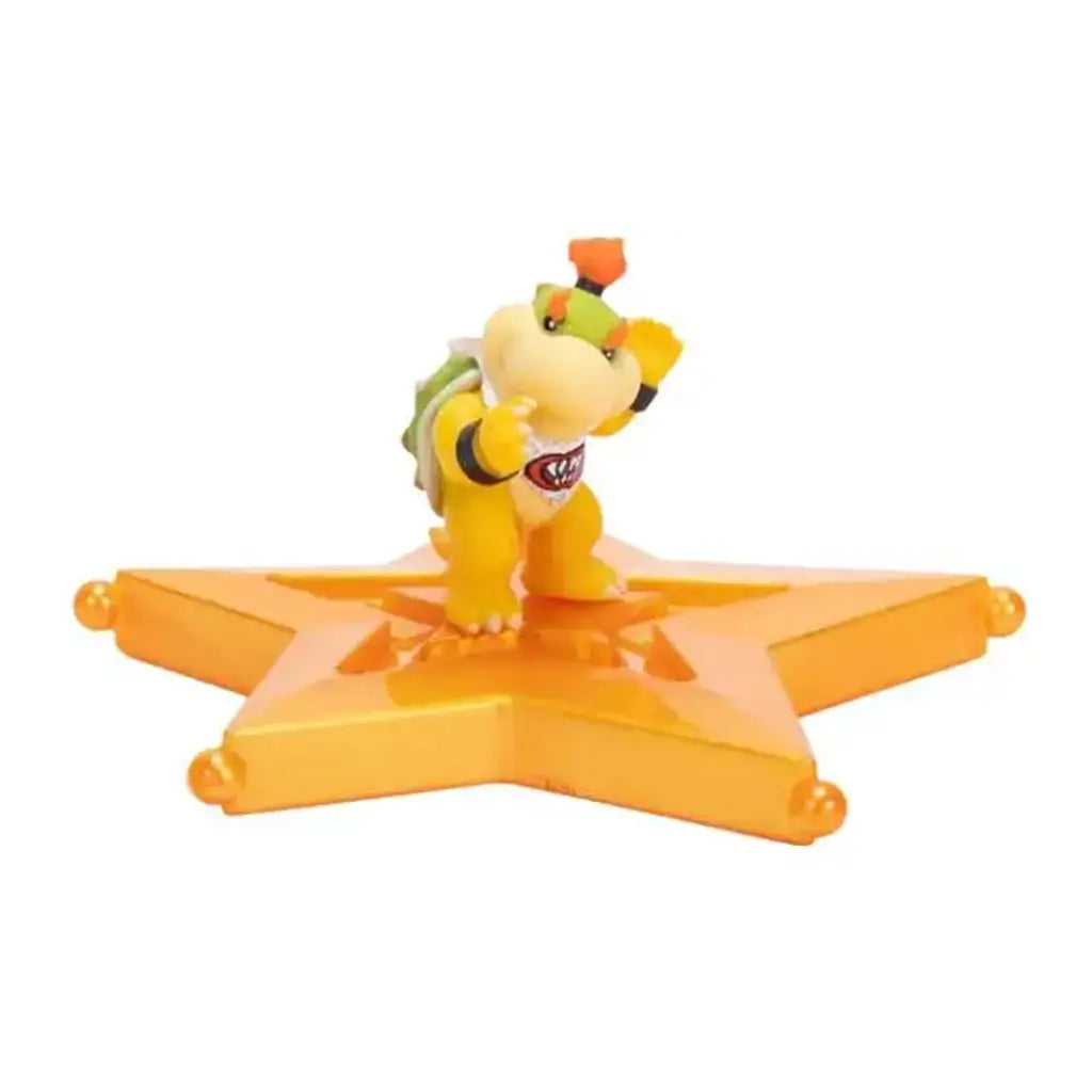 Super Mario Galaxy Movie Bowser Jr. figure features yellow plastic, a green shell and orange crest, posed with raised fists on a glossy orange star platform against white.