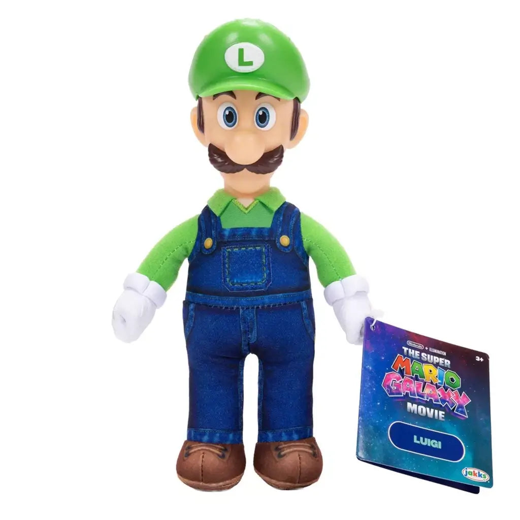 Luigi plush toy from The Super Mario Galaxy Movie features soft green fabric, blue overalls, white gloves, brown shoes, green L cap, embroidered eyes, mustache, and retail tag.