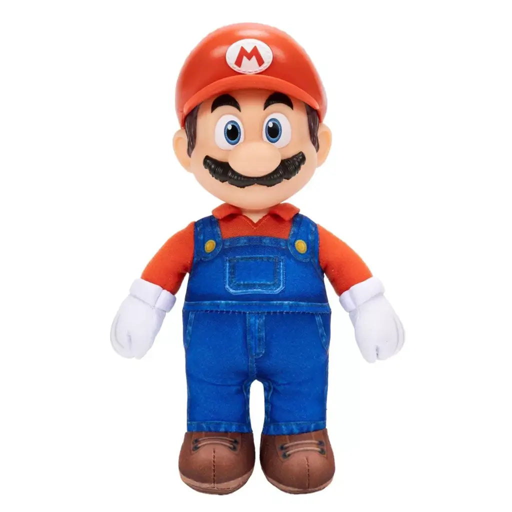 Mario plush toy from The Super Mario Galaxy Movie features soft red and blue fabric, blue overalls, white gloves, brown shoes, red M cap, blue eyes, and black mustache.