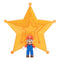 Super Mario Galaxy Movie Mario figure wears red and blue overalls with white gloves and brown shoes, standing before a large translucent orange-gold star on white.