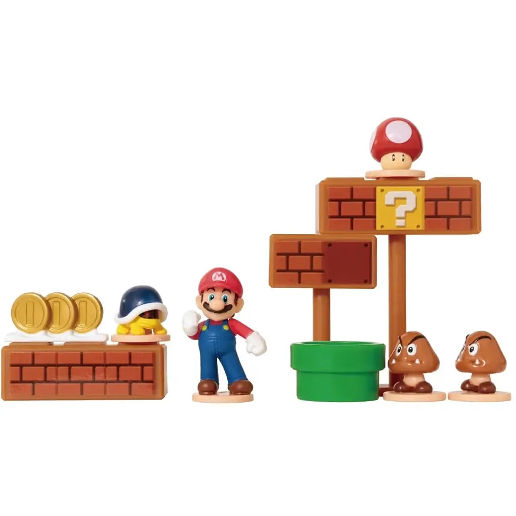 Super Mario Micro Game World playset showing detailed plastic mini figures including Mario, Goombas, coins, green pipe, and mushroom power-up arranged on brick-style platforms.