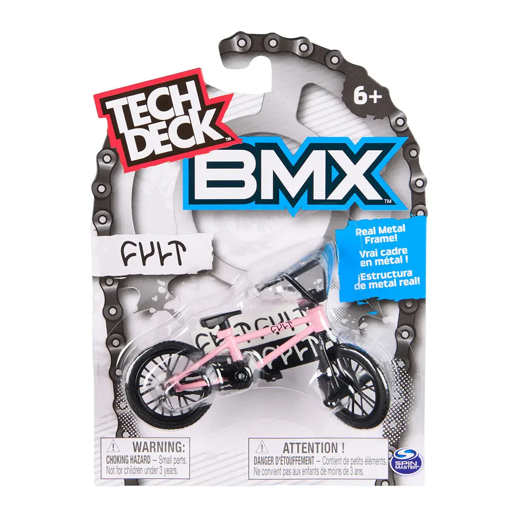 Tech Deck BMX toy packaging in white cardboard and clear plastic blister, rounded top form with chain graphic border, displaying pink FULT BMX bike, bold branding, age label, and safety warning on a clean background.