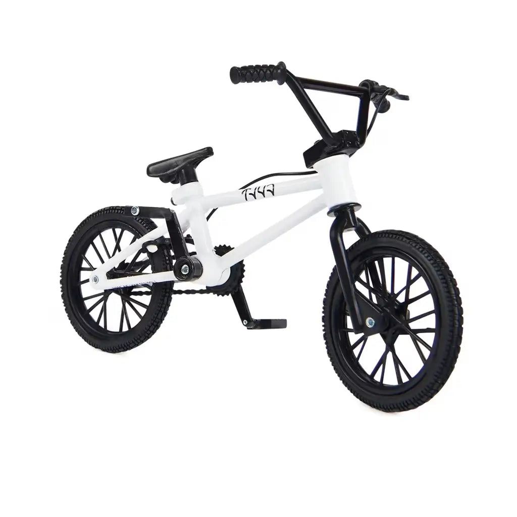 Tech Deck BMX finger bike in white metal frame with black rubber tires, compact stunt bike form with pegs, pedals, and handlebars, designed for freestyle tricks on a clean white background.