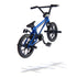 Tech Deck BMX finger bike in blue and black metal and plastic, compact stunt frame with spoked wheels, rear pegs, and pedals, designed for tricks, shown in midair on a minimal white background.