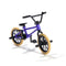 Tech Deck BMX finger bike in purple metal frame with black plastic components and tan rubber tires, compact freestyle stunt design with pegs, pedals, and handlebars on a clean white background.