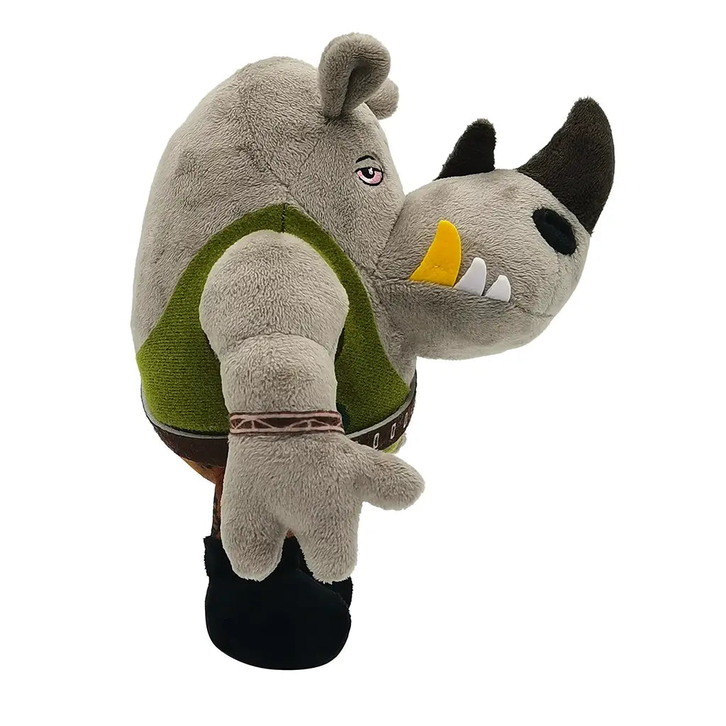 Gray rhino Rocksteady plush figure from Teenage Mutant Ninja Turtles, wearing a green vest and camo pants, shown in side profile with detailed horn and tusks.