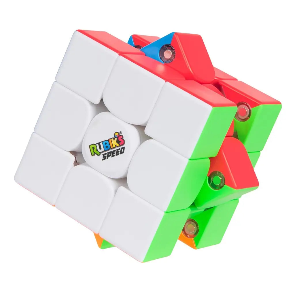 Rubik’s Speed Cube 3x3 puzzle in white, green, red, and blue plastic with rounded edges, partially turned layers revealing internal mechanism, compact cube form on a clean white background.
