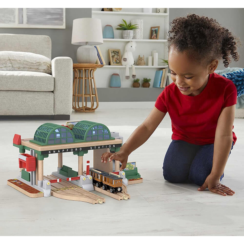 child playing with the Fisher-Price Thomas & Friends Wooden Railway Knapford Station Passenger Pickup Train Set
