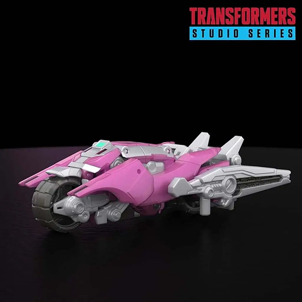 Transformers Elita-1 pink and silver plastic trike with sleek aerodynamic body, rounded front wheel and tapered wings displayed on a dark studio surface with subtle reflections.