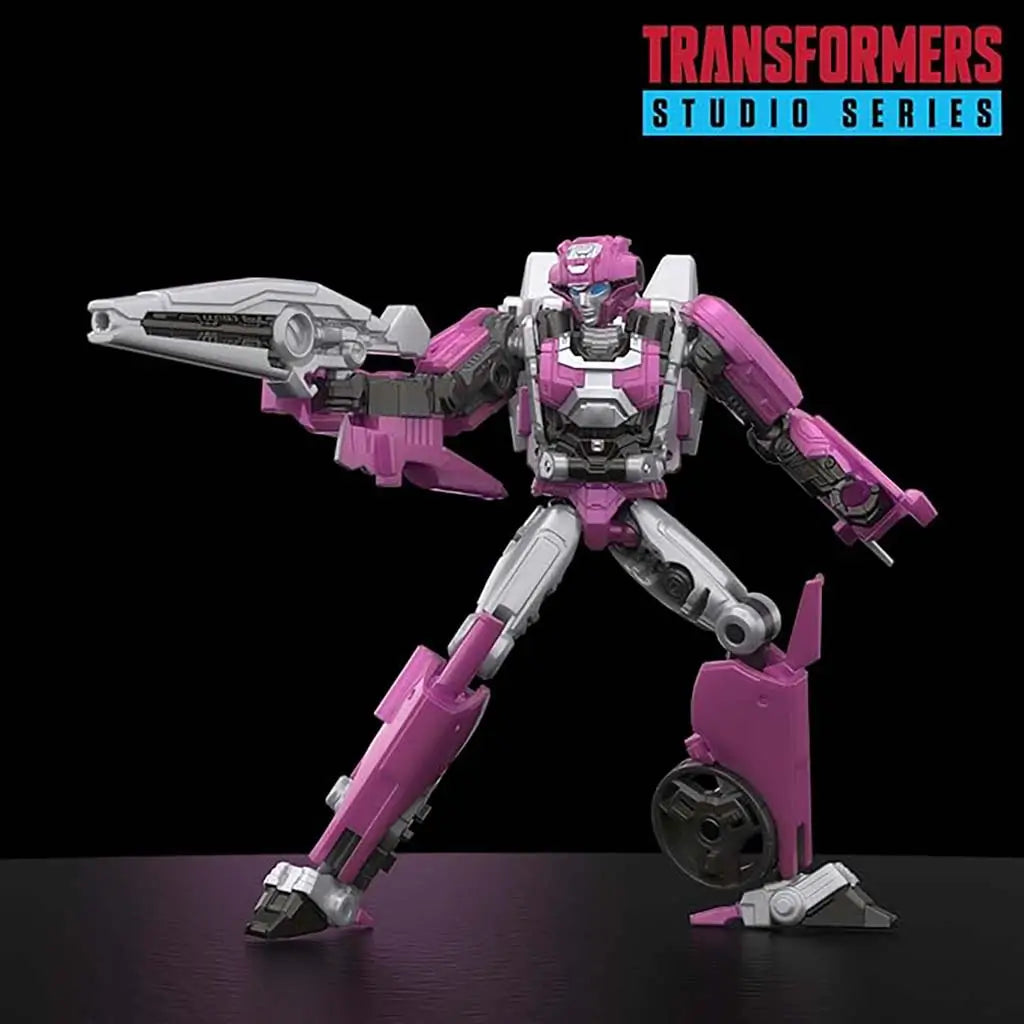 Transformers Elita-1 pink and silver articulated action figure with detailed armor panels, angular limbs and a large rifle posed dynamically on a dark studio background.