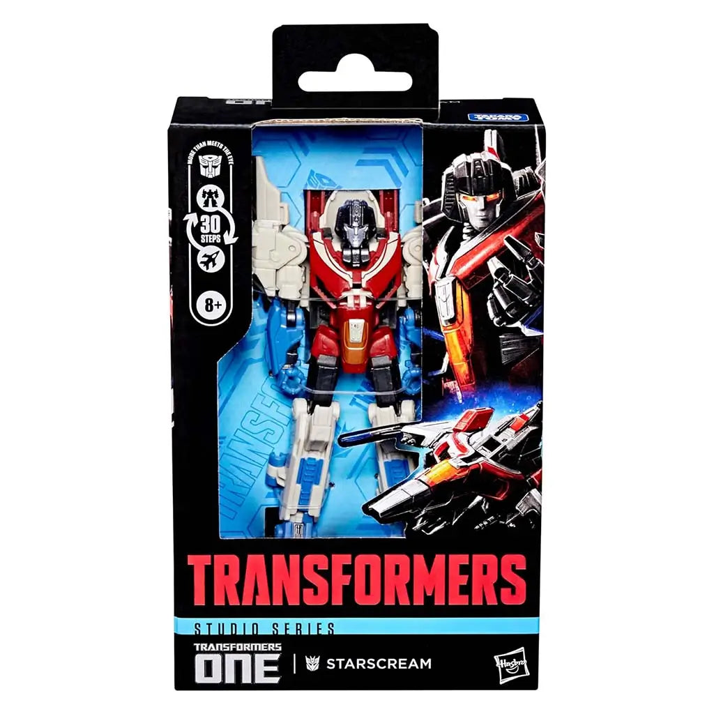Transformers ONE Starscream Studio Series packaging with clear window displaying the articulated red, blue, and beige robot figure, character art, and branding details on a bold black-and-blue box.