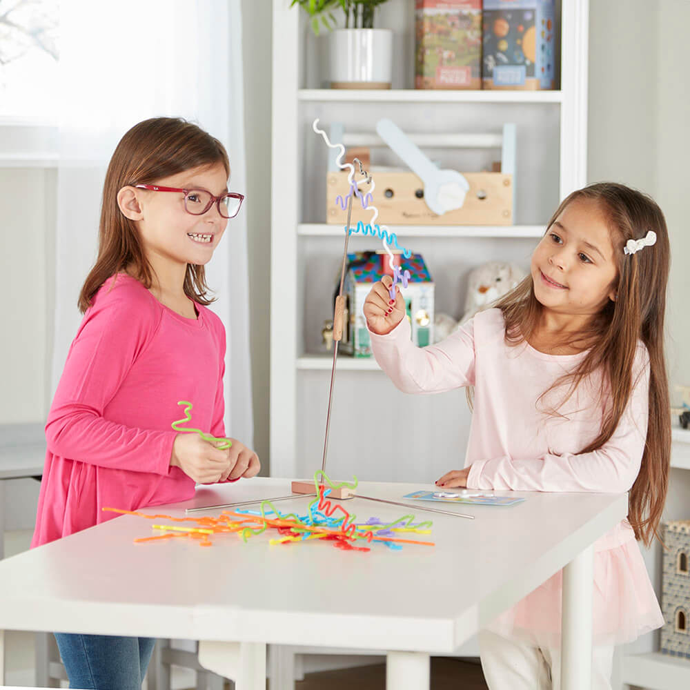 Two girls playing the Melissa and Doug Suspend Junior Balance Game