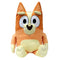 Bluey Bingo plush toy in orange and cream soft fabric with upright ears and rounded limbs, upright seated form, large oval eyes and smiling face, cuddly character plush, isolated on white background