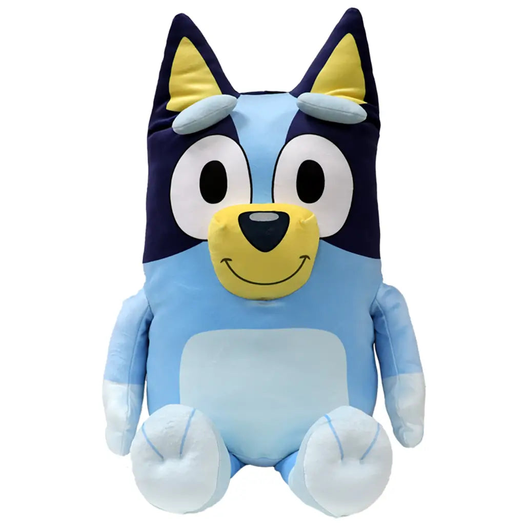 Bluey plush toy in light and dark blue soft fabric with cream muzzle and inner ears, upright seated form with rounded limbs, large oval eyes and smiling face, cuddly plush isolated on white background