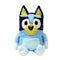 Bluey plush toy in light and dark blue soft fabric with cream muzzle and inner ears, upright seated form with rounded limbs, large oval eyes and smiling face, cuddly plush isolated on white background