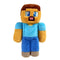 Minecraft Steve plush toy in tan and blue soft fabric with blocky pixel-style character shape, featuring square head, blue shirt, purple pants, and embroidered facial details on a white background.