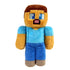 Minecraft Steve plush toy in tan and blue soft fabric with blocky pixel-style character shape, featuring square head, blue shirt, purple pants, and embroidered facial details on a white background.