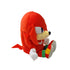 Sonic Knuckles plush toy in bright red soft fabric with rounded character shape, shown in side profile with long dreadlock-like quills, white gloves and multicolor shoes, displayed on a plain white background.