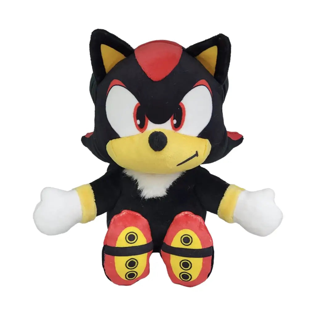 Sonic the Hedgehog Shadow plush toy in black and red soft fabric with yellow muzzle and accents, upright seated form with outstretched arms, red eyes and confident expression, plush on white