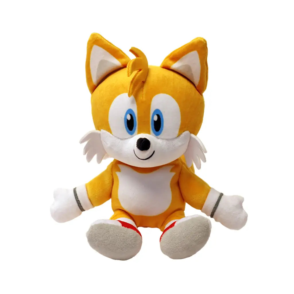 Sonic Tails plush toy Ty Beanie Babies character in orange and white soft fabric, rounded fox form with blue eyes and twin tails, seated facing forward against a plain white studio background.