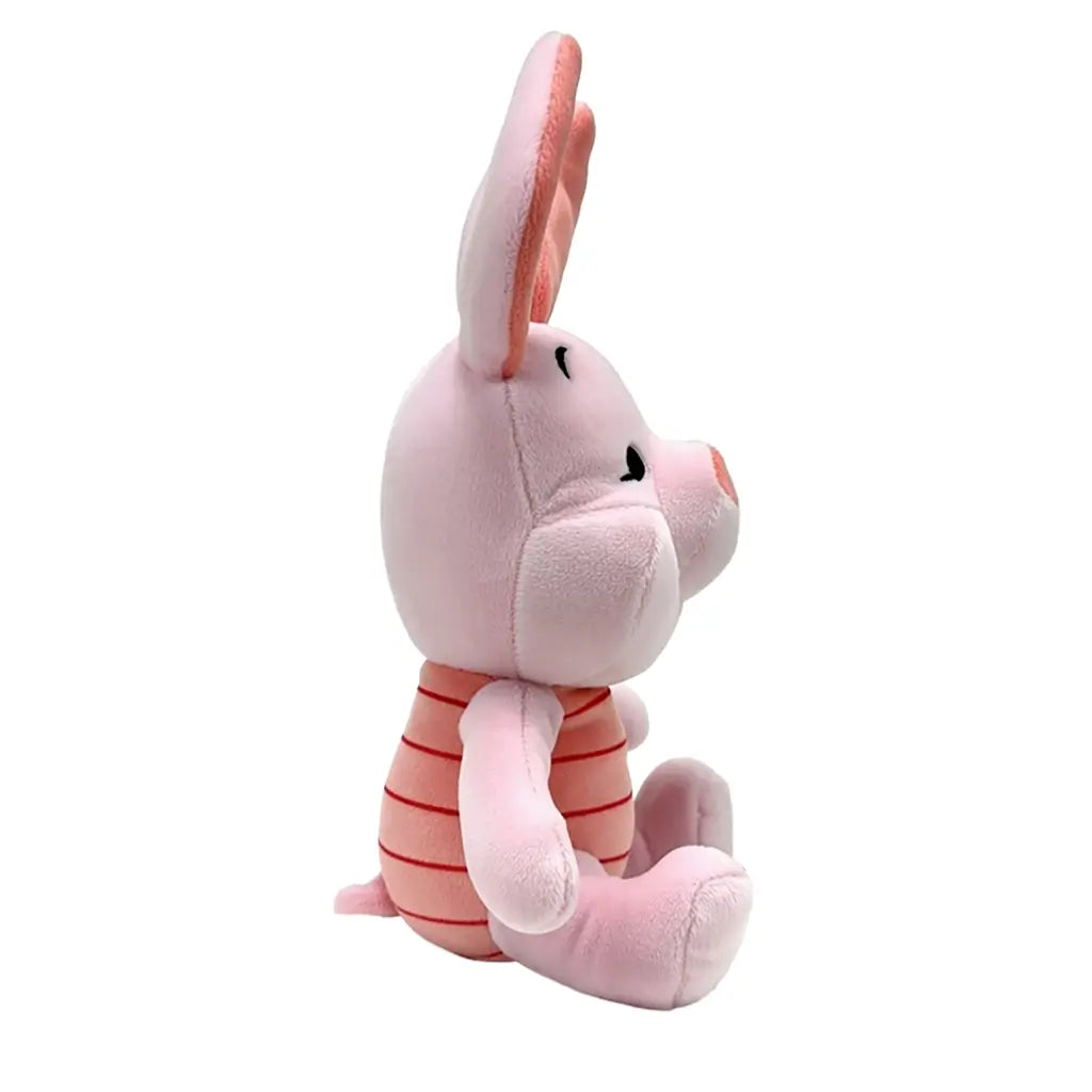 Disney Piglet plush toy in soft light pink fabric with rounded character shape, shown in side profile with large upright ears, striped pink torso, and embroidered facial details on a white background.