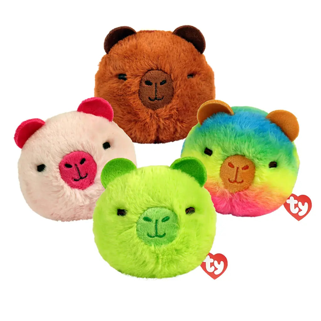 TY Beanie Bouncers capybara plush toys, multicolor fuzzy fabric in brown, cream, green, and rainbow hues, rounded soft bouncer shapes with ears and embroidered faces, grouped on a light background.