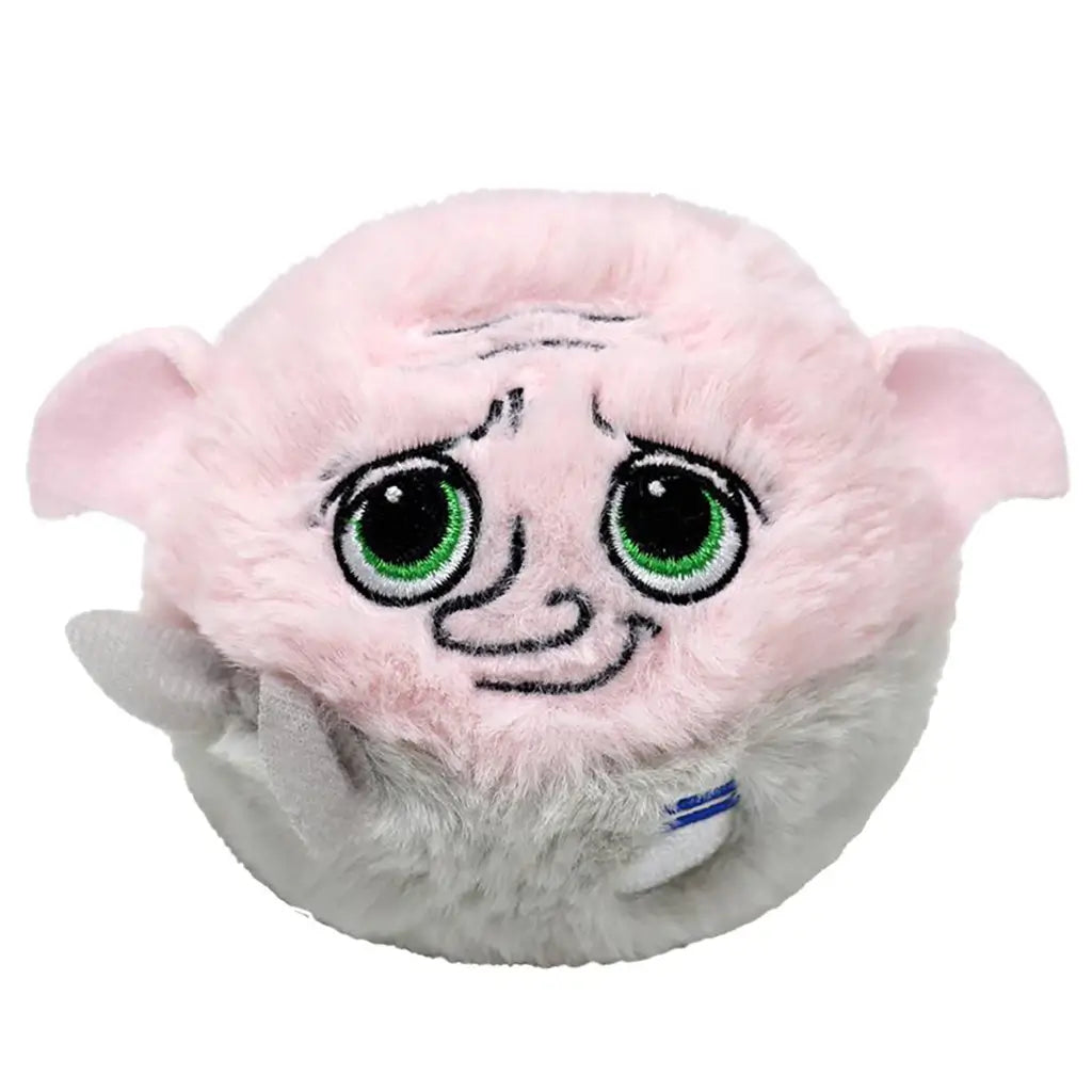 Round plush Dobby toy from Harry Potter with pink fabric, large green glittery eyes, embroidered wrinkles, floppy ears, and gray lower body, designed as a Ty Beanie Bouncer collectible.