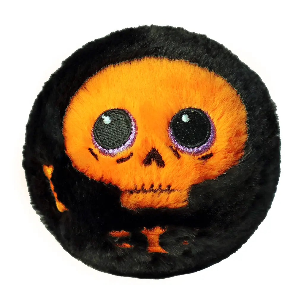 Round plush toy with bright orange skeleton face, purple-rimmed black eyes, and soft black body, designed as a spooky Ty Beanie Bouncer collectible named Marrow for Halloween.