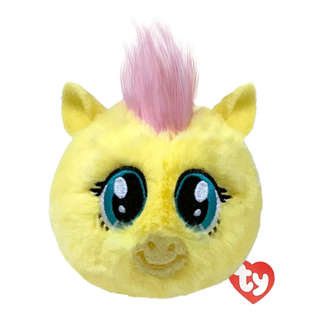 My Little Pony Fluttershy plush toy in soft pastel yellow fabric with light pink tufted mane, rounded ball shape, large teal eyes and gentle smiling face, bounceable plush isolated on white background