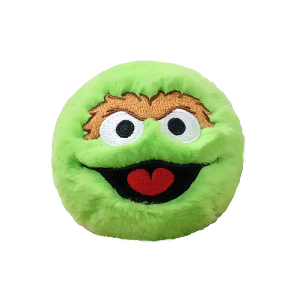 Sesame Street Oscar plush toy features bright green fuzzy fabric, round soft cushion shape, wide white and black eyes with brown brows, open smiling mouth with red tongue, and shaggy texture on a plain white background