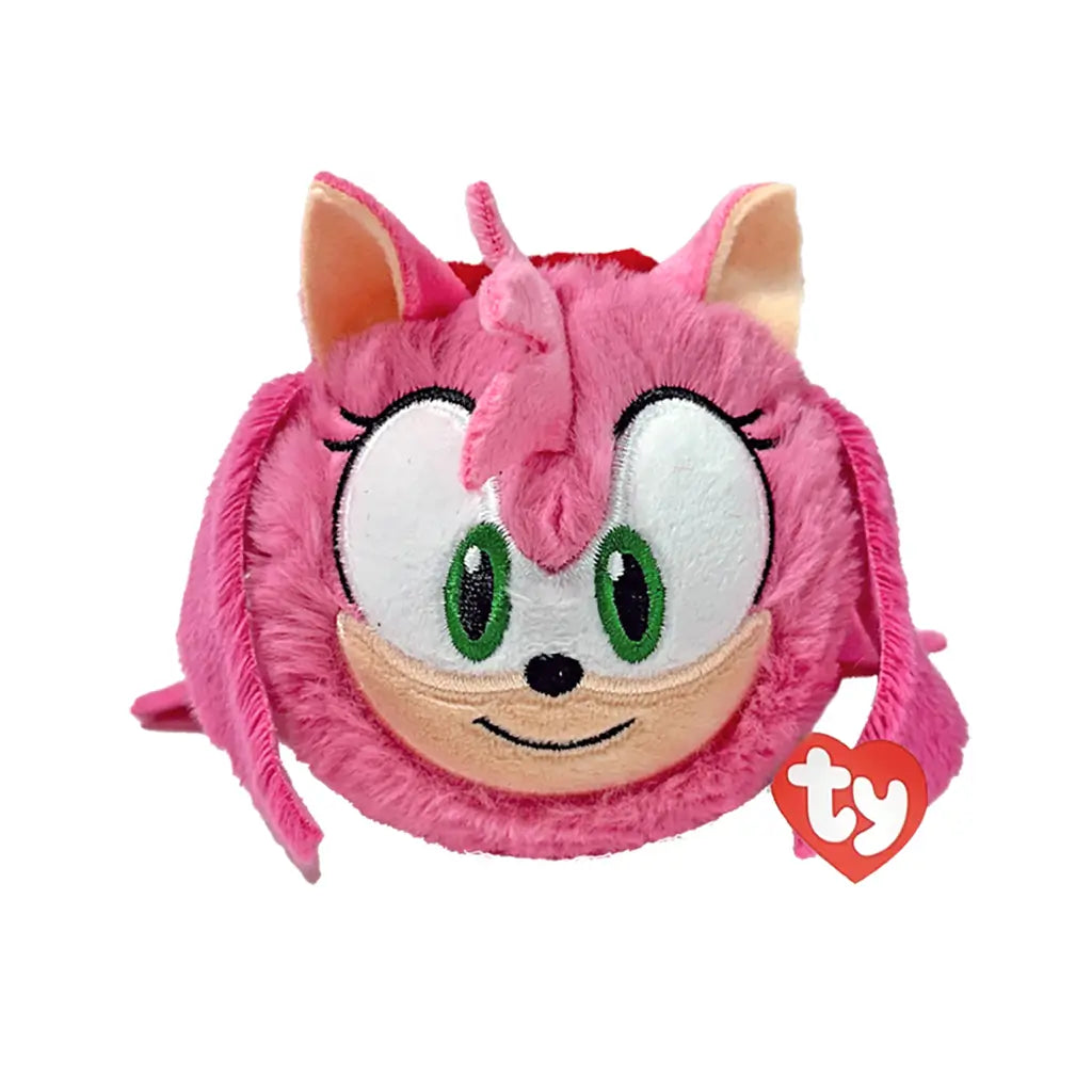 Sonic the Hedgehog Amy plush toy in bright pink soft fabric with tan muzzle and green eyes, rounded ball shape, smiling face with side quills and fringe, bounceable plush, isolated on white background