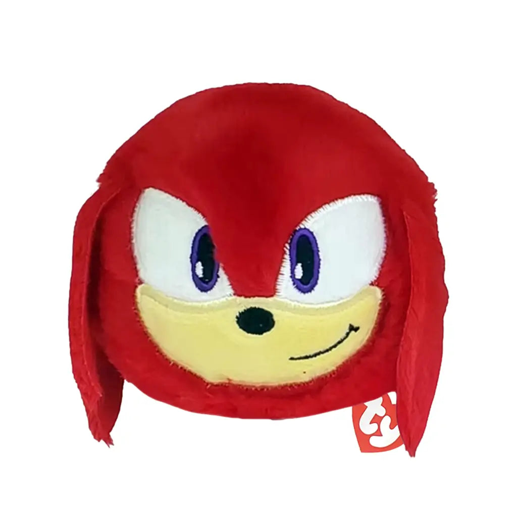 Sonic the Hedgehog Knuckles plush toy in bright red soft fabric with tan muzzle and purple eyes, rounded ball shape, smiling face with long side locks, bounceable plush isolated on white background