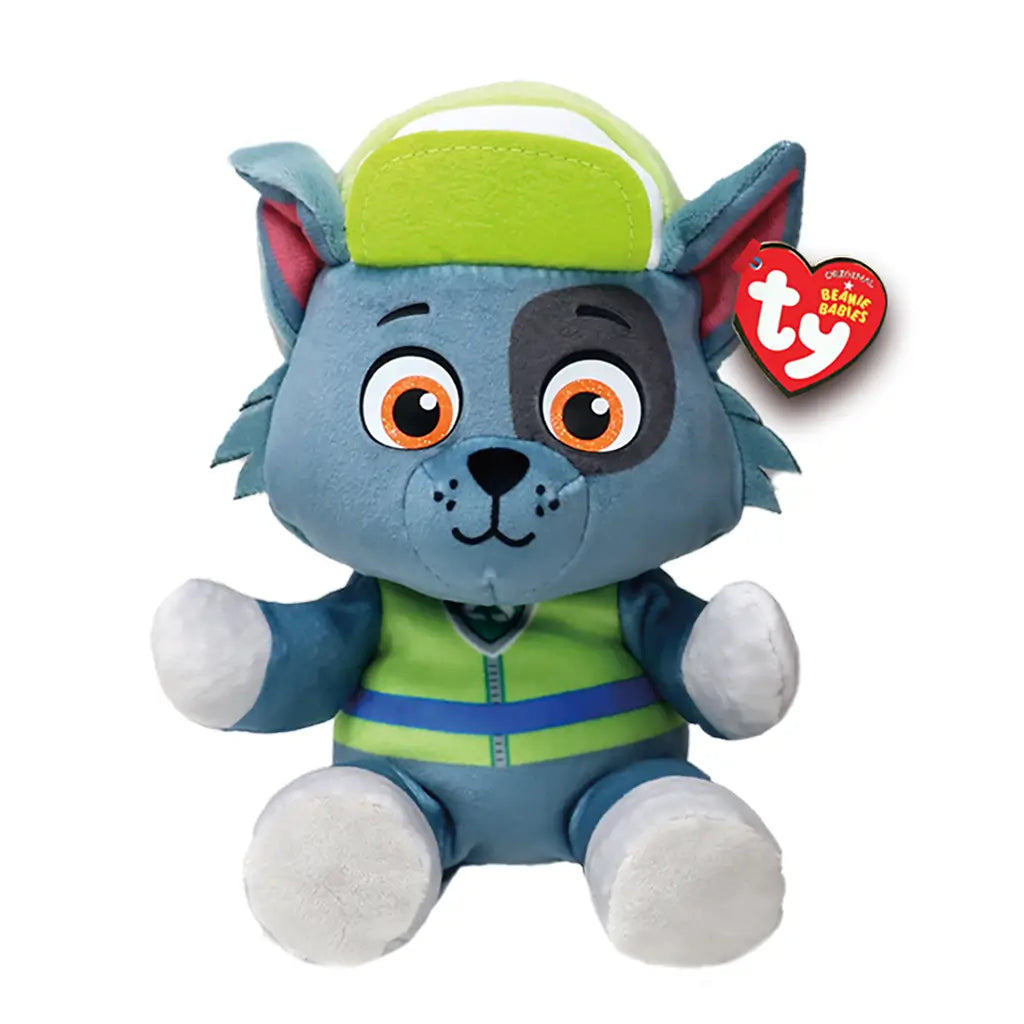 Rocky Paw Patrol plush toy Ty Beanie Babies in gray and green soft fabric, seated dog shape with embroidered face, orange eyes, green cap and vest, recycling pup character design on white background.