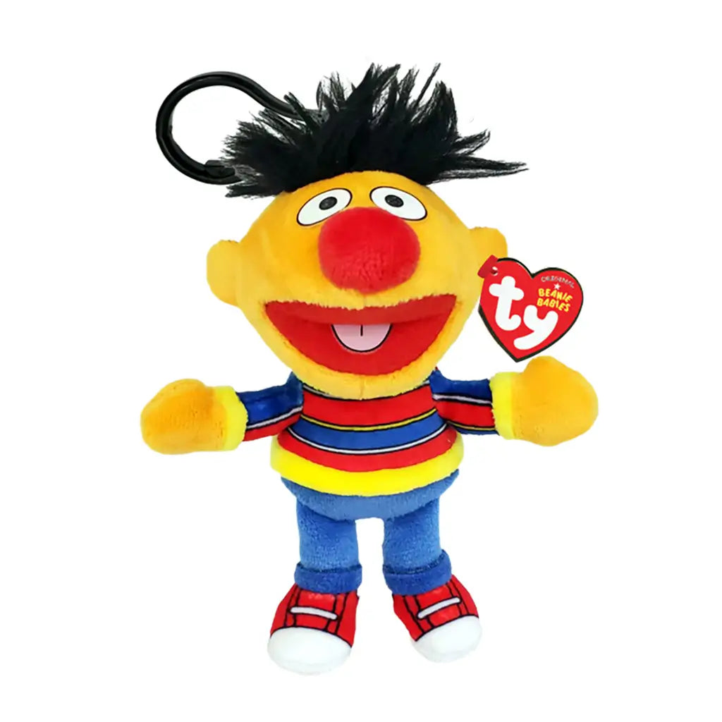 Sesame Street Ernie plush clip in yellow soft fabric, with black hair, red nose, striped shirt, blue pants and red shoes, shown with a TY Beanie Babies tag on white.
