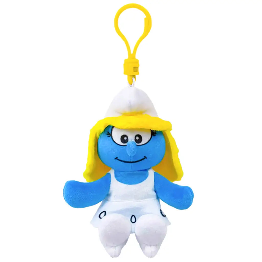 Smurfs Smurfette plush clip in blue soft fabric, with long yellow hair, white hat and dress, embroidered eyes and smiling face, hanging from a yellow plastic hook on white.
