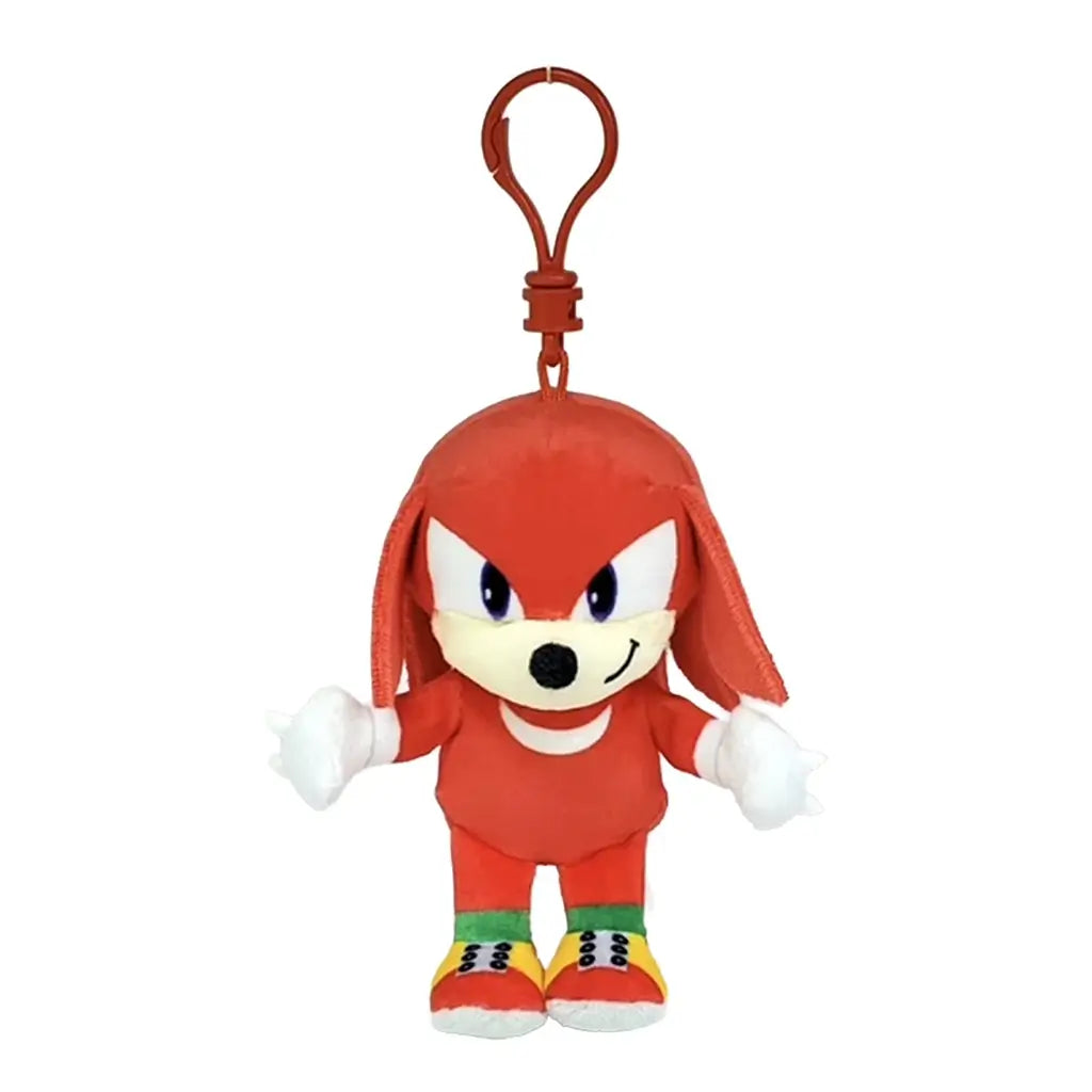 Sonic the Hedgehog Knuckles plush clip in red soft fabric, with tan muzzle, purple eyes, white spiked gloves and colorful shoes, hanging from a red plastic hook on white.