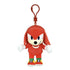 Sonic the Hedgehog Knuckles plush clip in red soft fabric, with tan muzzle, purple eyes, white spiked gloves and colorful shoes, hanging from a red plastic hook on white.