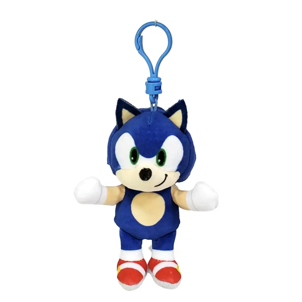 Sonic the Hedgehog plush clip in blue soft fabric, with green eyes, tan muzzle and belly, white gloves and red shoes, hanging from a blue plastic hook on a white background.