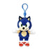 Sonic the Hedgehog plush clip in blue soft fabric, with green eyes, tan muzzle and belly, white gloves and red shoes, hanging from a blue plastic hook on a white background.
