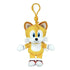 Sonic the Hedgehog Tails plush clip in golden yellow soft fabric, with blue eyes, white muzzle and chest, white gloves and red shoes, hanging from a yellow hook on white.
