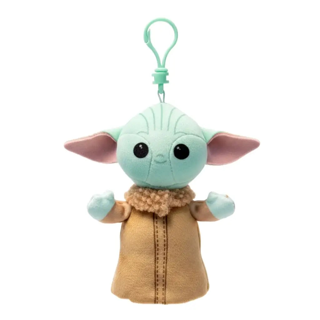 Star Wars Grogu plush clip in pale green soft fabric, with wide pink-lined ears, black eyes and tan robe with fuzzy collar, hanging from a mint green plastic hook on white.