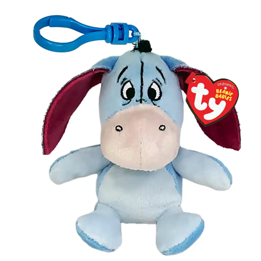 Eeyore plush clip in pale blue soft fabric, with floppy purple-lined ears, cream muzzle, embroidered face and blue plastic hook, displayed with a TY Beanie Babies tag on white.