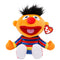 Sesame Street Ernie plush toy in orange soft fabric with black fuzzy hair, a red nose, striped shirt, white shoes, and a red Ty Beanie Babies tag on a white background.