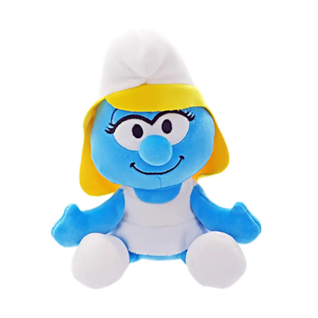 Blue Smurfs Smurfette plush toy by Ty features soft fabric, yellow hair, a rounded seated form, white hat and dress, smiling face, and white feet on white.