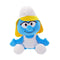 Blue Smurfs Smurfette plush toy by Ty features soft fabric, yellow hair, a rounded seated form, white hat and dress, smiling face, and white feet on white.