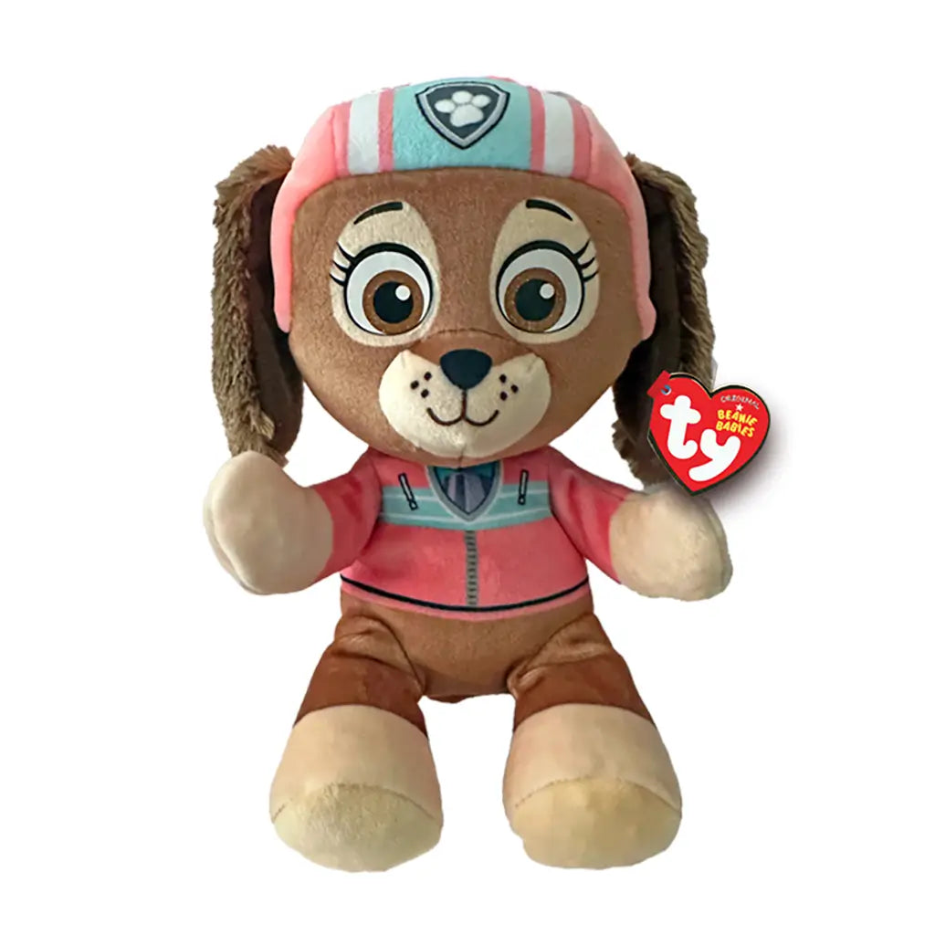 Paw Patrol Liberty plush toy in brown and tan soft fabric with rounded dachshund shape, wearing pink helmet and jacket with teal accents, featuring large brown eyes and floppy ears on white backgroun