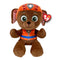 Paw Patrol Zuma plush toy in brown soft fabric with rounded puppy shape, wearing an orange rescue helmet and vest with blue accents, featuring large green eyes and floppy ears, on a white background.